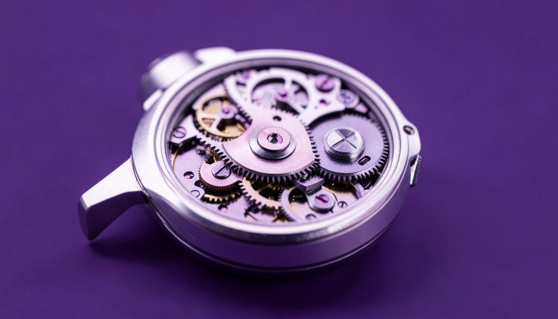 Close-up of a watch movement in steel and violet tones, gears layered on a softly lit background